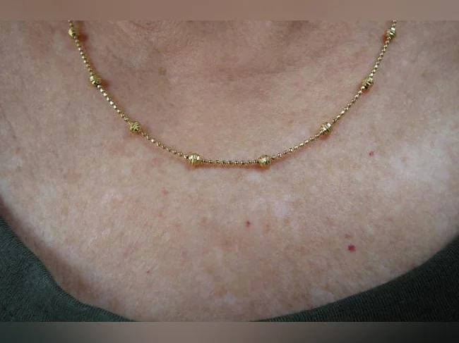 Chaîne en acier inoxydable , plaquée Or 14 K. avec Billes fixes .