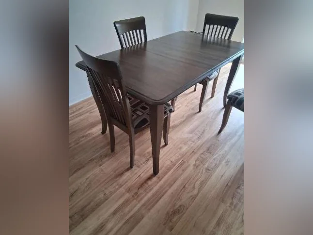 Table en bois de merisier avec quatre chaises assorties.